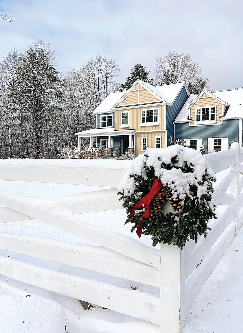 wreath on the corner of fence with view to exterior of Pantry Hill dusted in snow