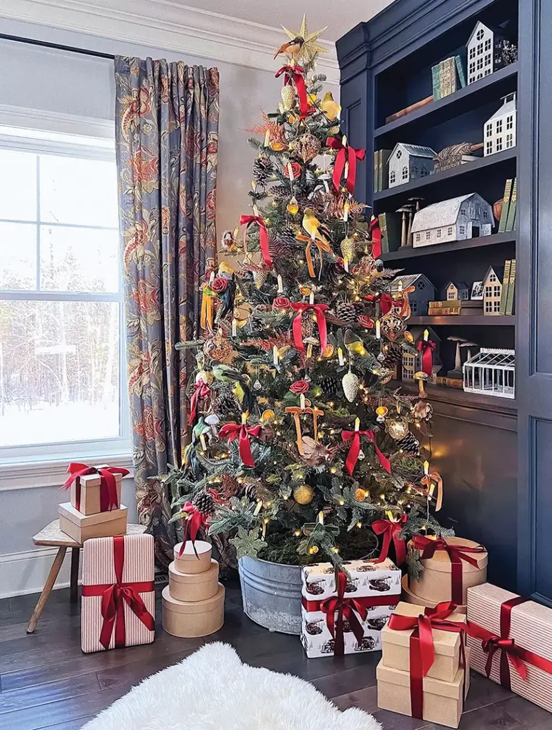 tree in galvanized tub decorated with pinecones and red ribbon