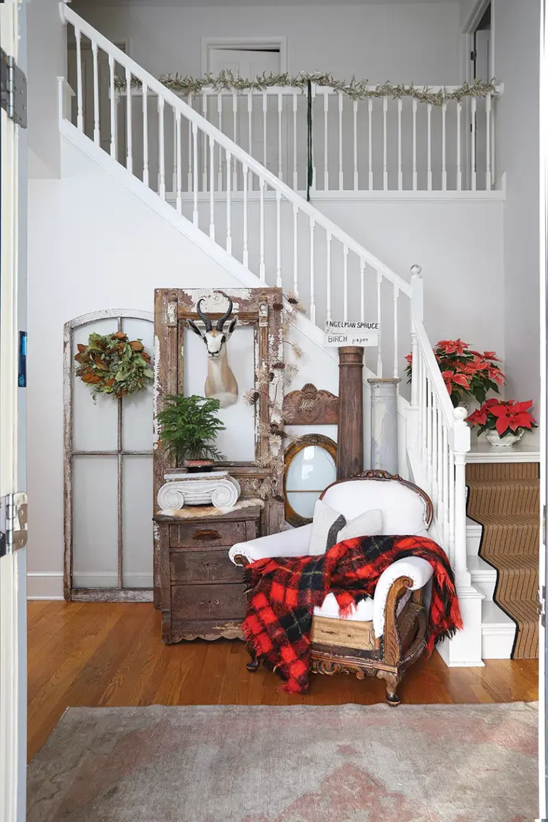 stairway with holiday decor from natural greenery such as potted tree and poinsettias