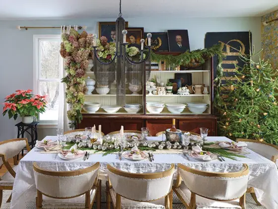 dining room with natural tree without ornaments and greenery as table runner