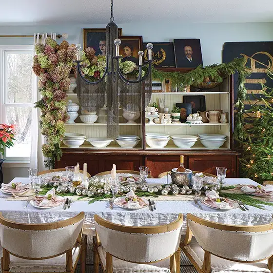 dining room with natural tree without ornaments and greenery as table runner