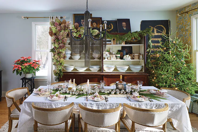 dining room with natural tree without ornaments and greenery as table runner