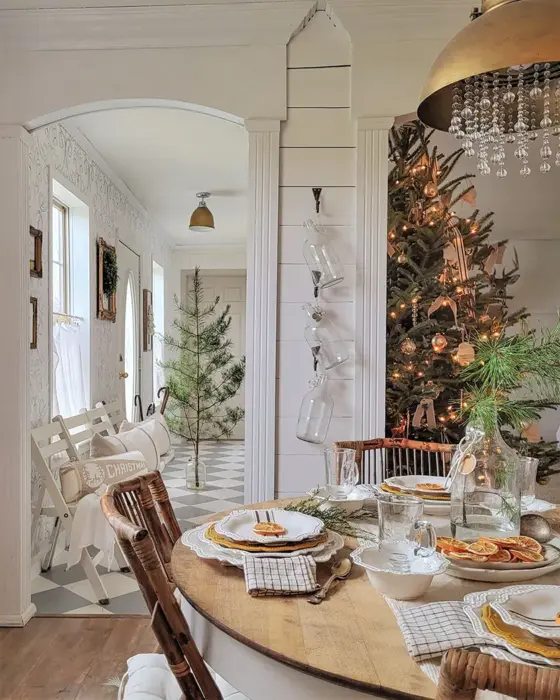 dining area with view to Christmas tree deocrated with lights and neutral ornaments