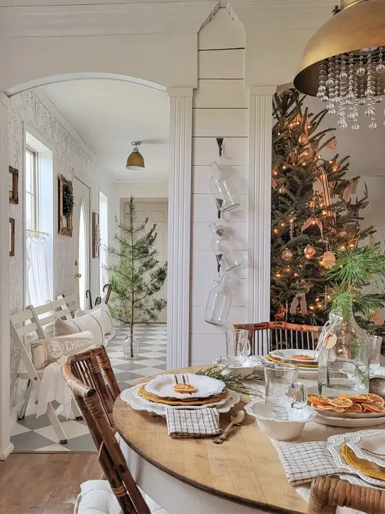 dining area with view to Christmas tree deocrated with lights and neutral ornaments