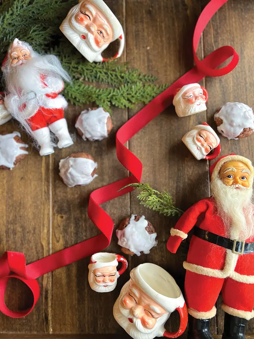 Santa figurines, mugs, red ribbon and homemade cookies