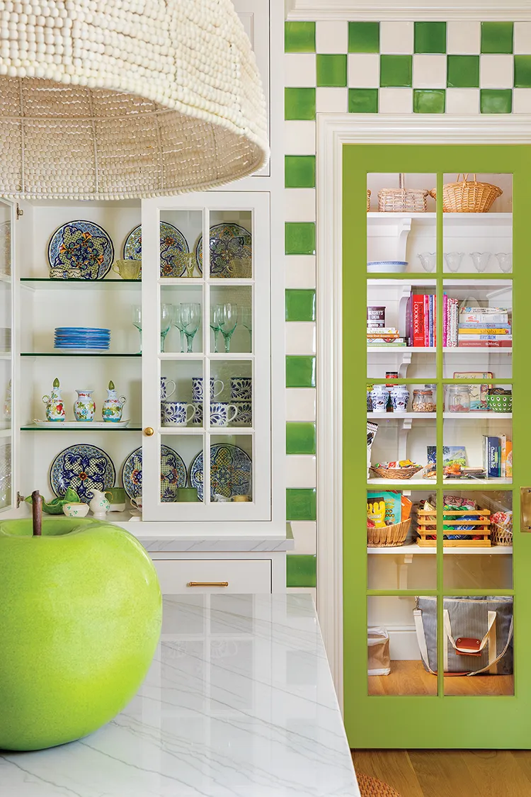 built-in display cabinets showcase colorful dishes in colorful kitchen