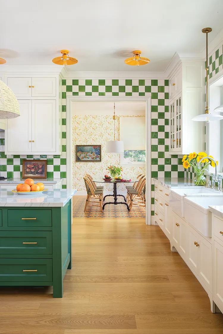 green and white tile and green cabinetry of the island bring color to the kitchen