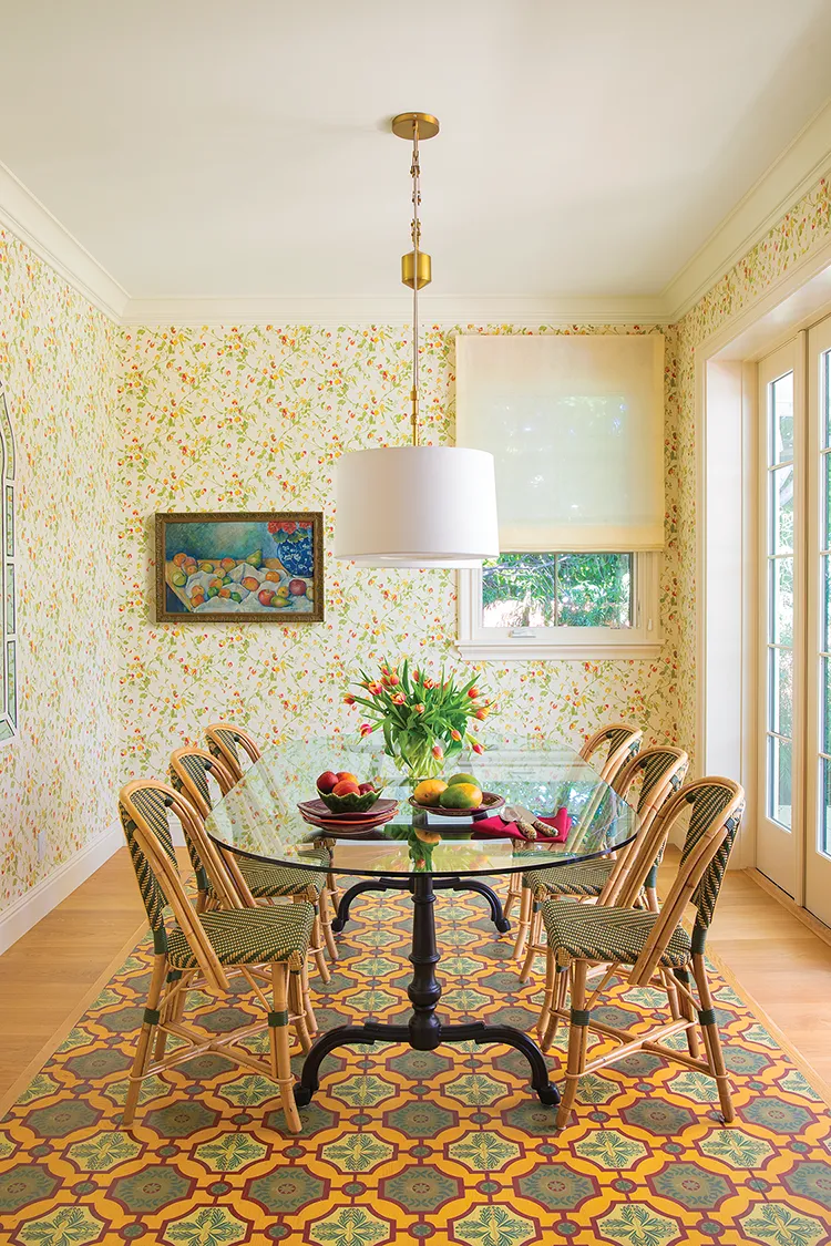 dining room with French bistro chairs and bright floral wallpaper