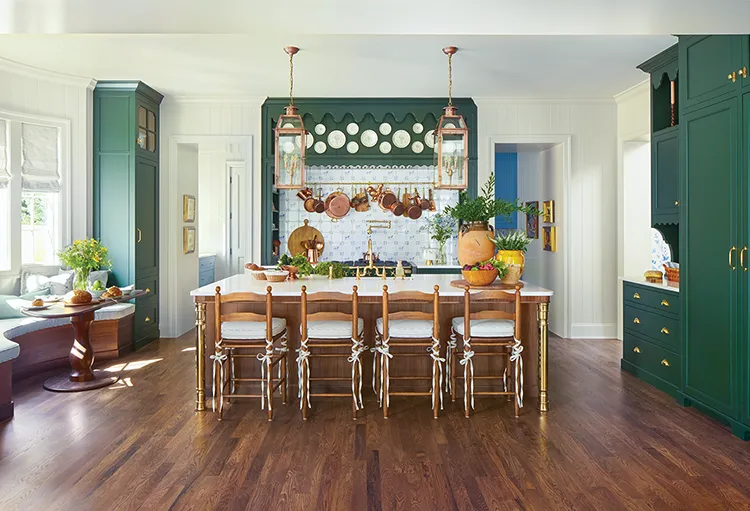 dark green cabinetry in Project House Utah kitchen with hanging copper pots and Delft tile backsplash