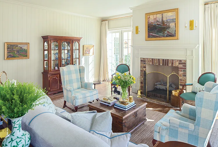 sitting room with fireplace , shiplap walls, landscape paintings and wildflower bouquet in Project House Utah