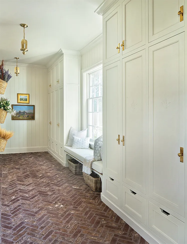 brick herringbone flooring and floor to ceiling storage cabinets in Project House Utah mudroom