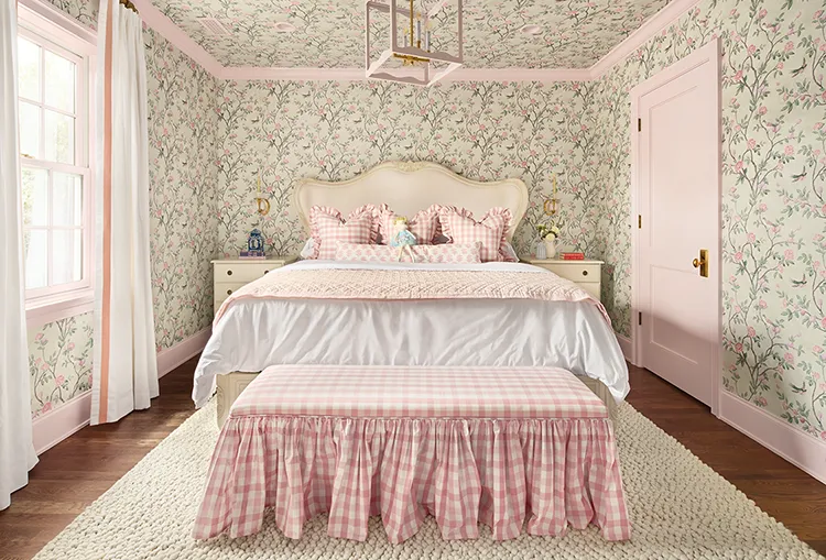 bedroom with pink door and trim, floral wallpaper and pink gingham bedding and bench in Project House Utah