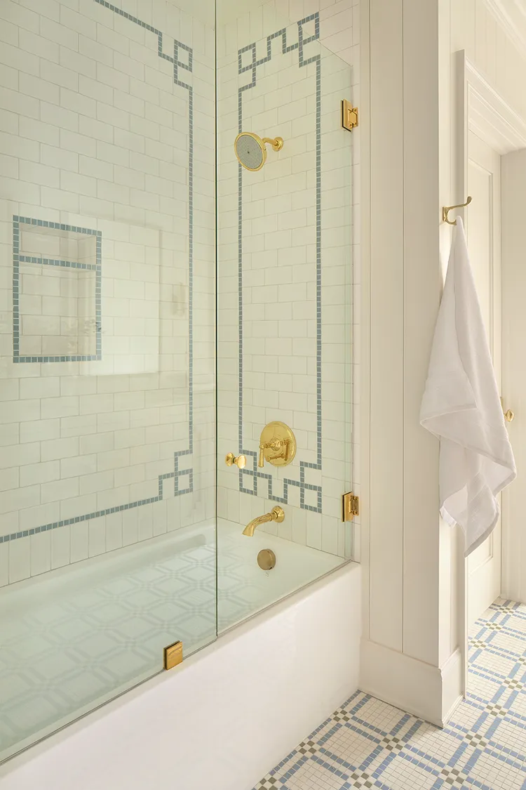 shower with white subway tile and blue scroll border in final reveal of Project House Utah