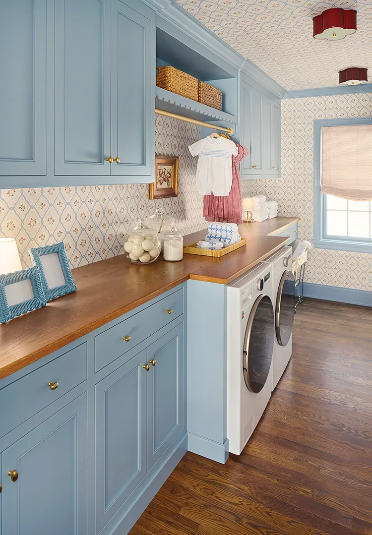 laundry room with powder blue cabinetry and trim