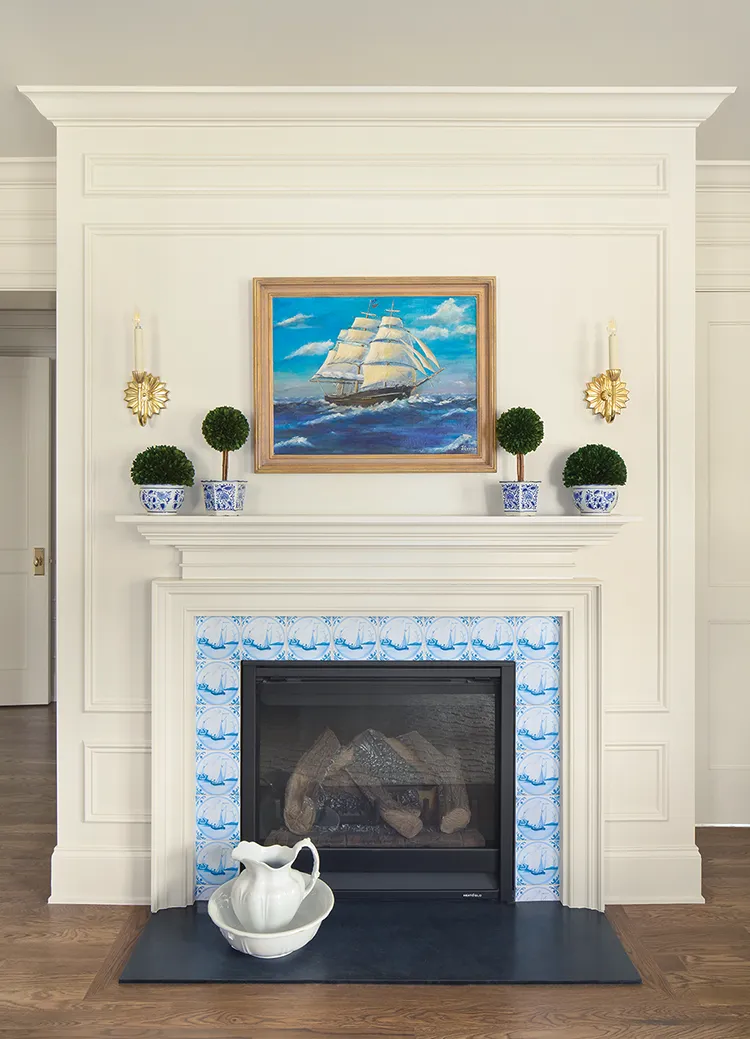 Delft tiles as fireplace surround with nautical painting above mantel in completed Project House Utah