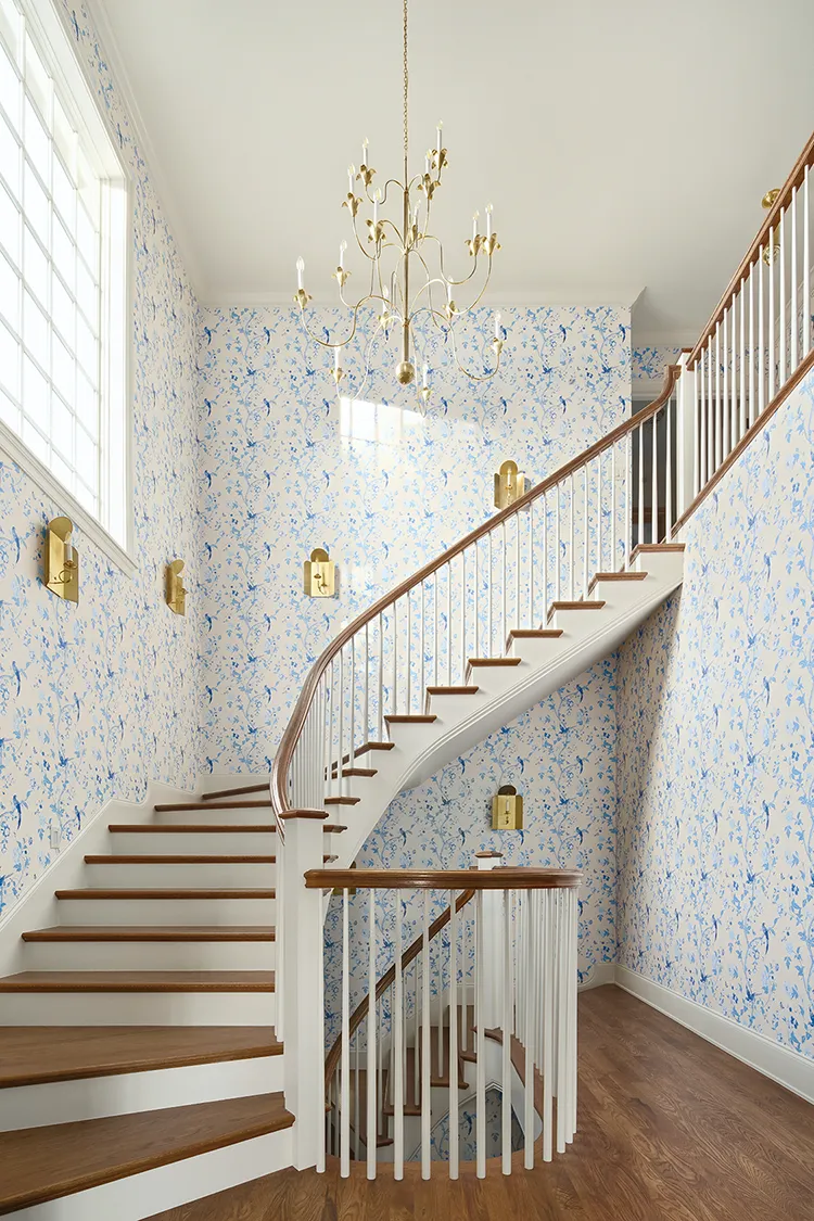 winding staircase with large chandelier in completed Project House Utah home