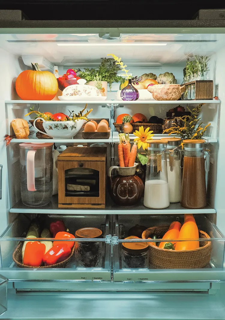 fall refrigerator with baskets and ceramic pitchers to organize produce