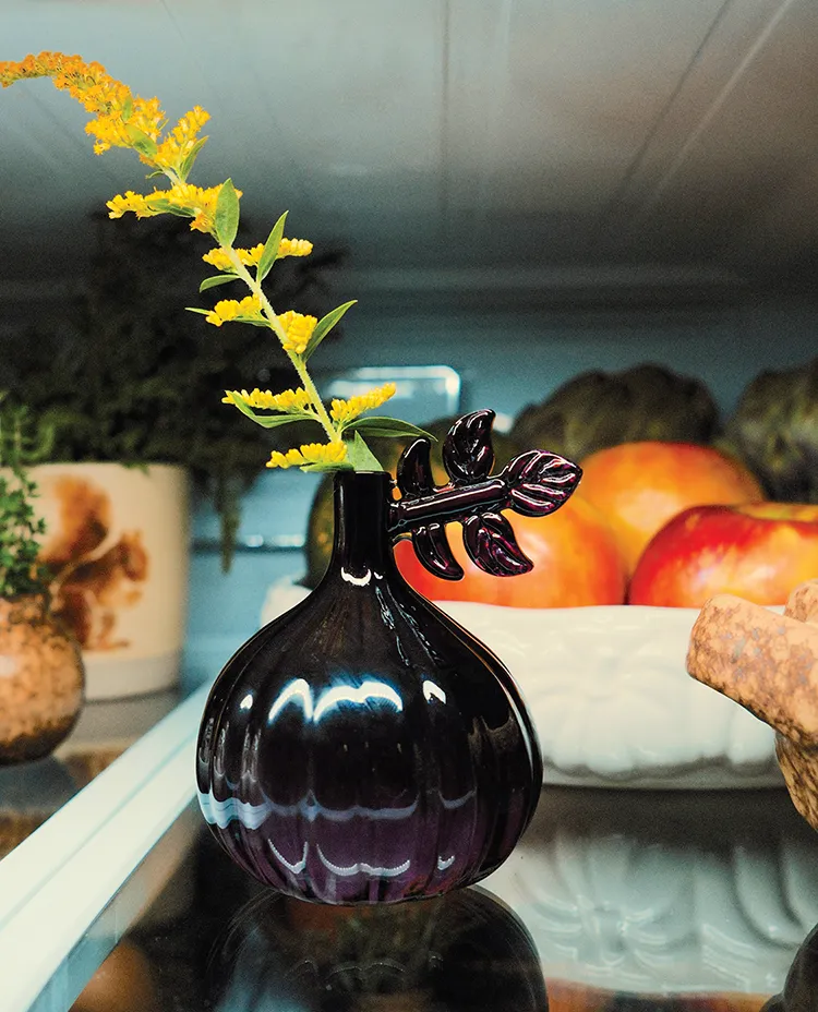 onion shaped bud vase with sprig of yellow flowers