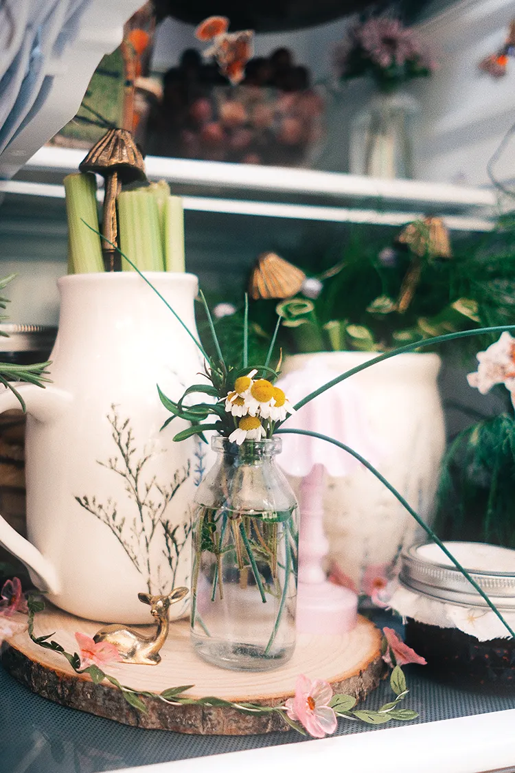 celery stored in white ceramic pitcher inside fridge