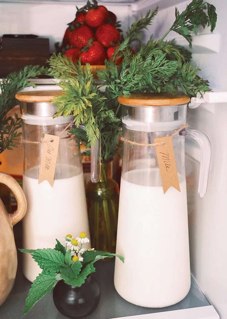 hand labeled milk containers with sprig of chamomile in front