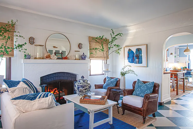 white and blue living room with fireplace in coastal cottage