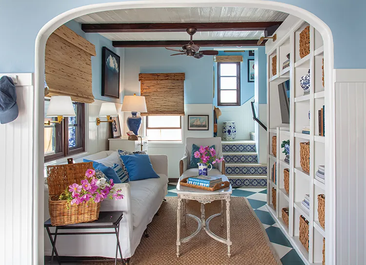 TV room with white built-in bookshelves in Spanish bungalow turned cozy cottage