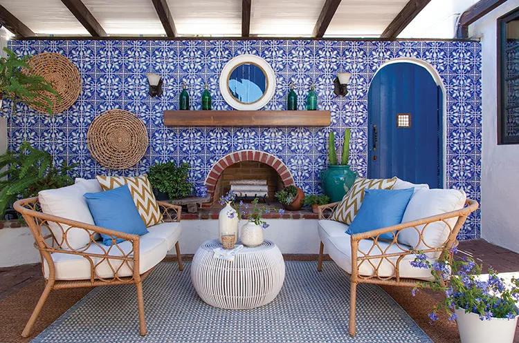 patio with blue and white tile wall and fireplace