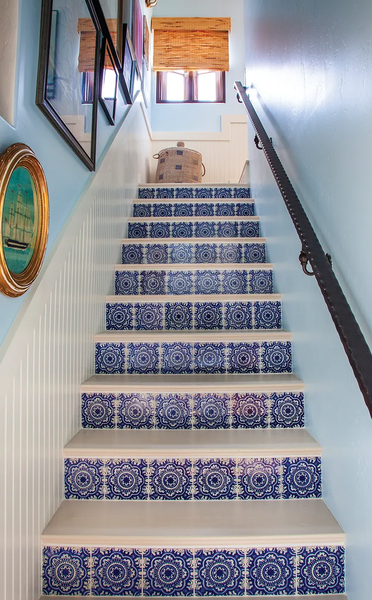 blue and white tile lining stairs in Spanish bungalow turned classic cottage