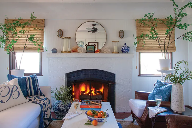 living room with fireplace in renovated Spanish bungalow turned coastal cottage