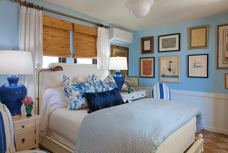 blue and white coastal cottage bedroom with gallery wall