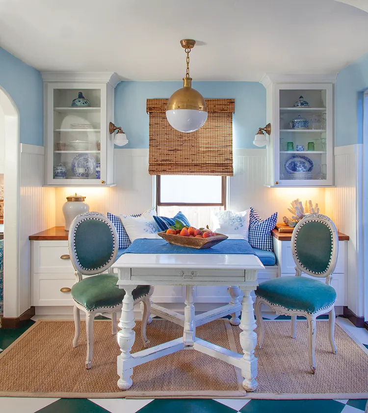 dining room with beadboard built in bench seating and display cabinets