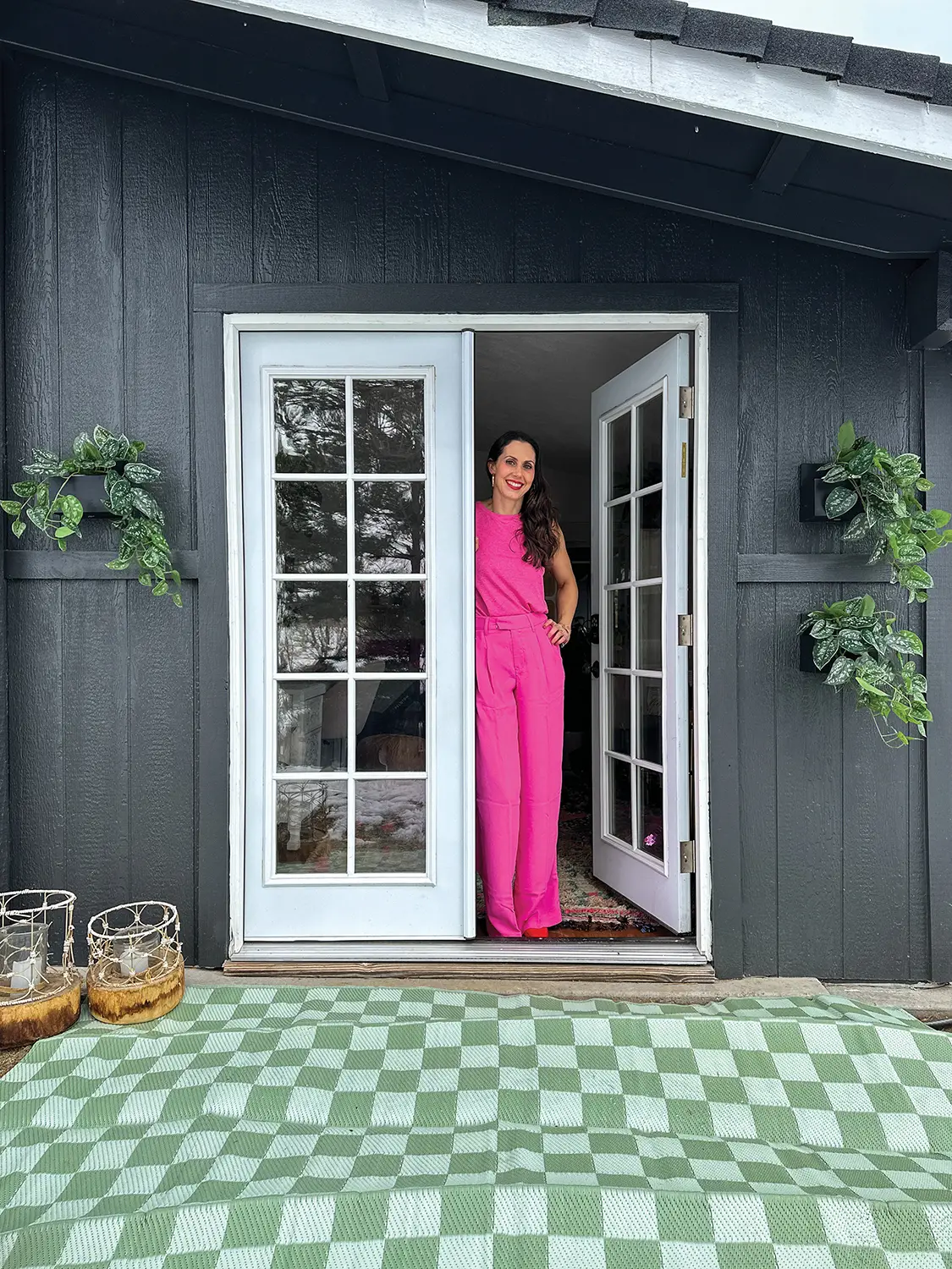 Jenny stands in exterior doorway to her hidden she shed