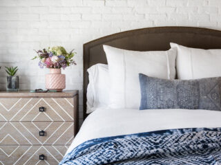 cottage bedroom with white sheets and blue comforter