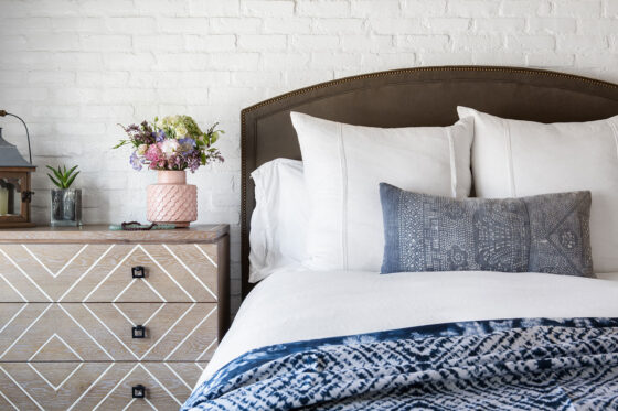 cottage bedroom with white sheets and blue comforter