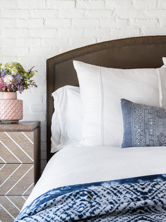 cottage bedroom with white sheets and blue comforter