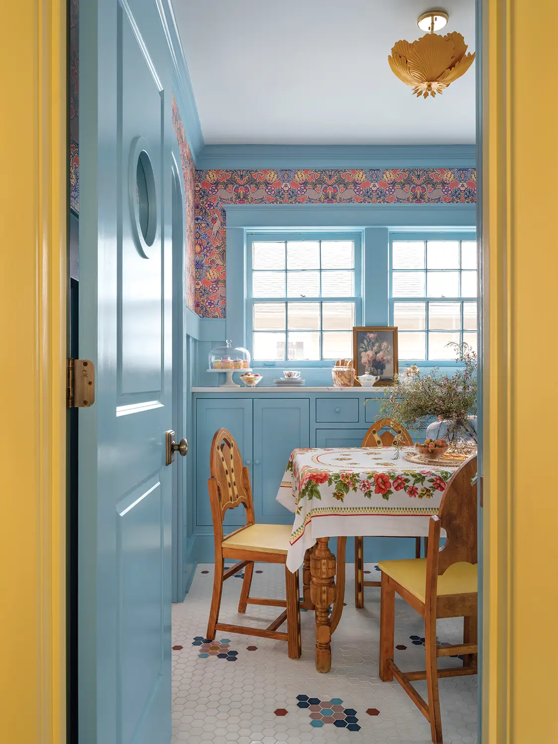 dining room with blue cabinetry and yellow chair upholstery