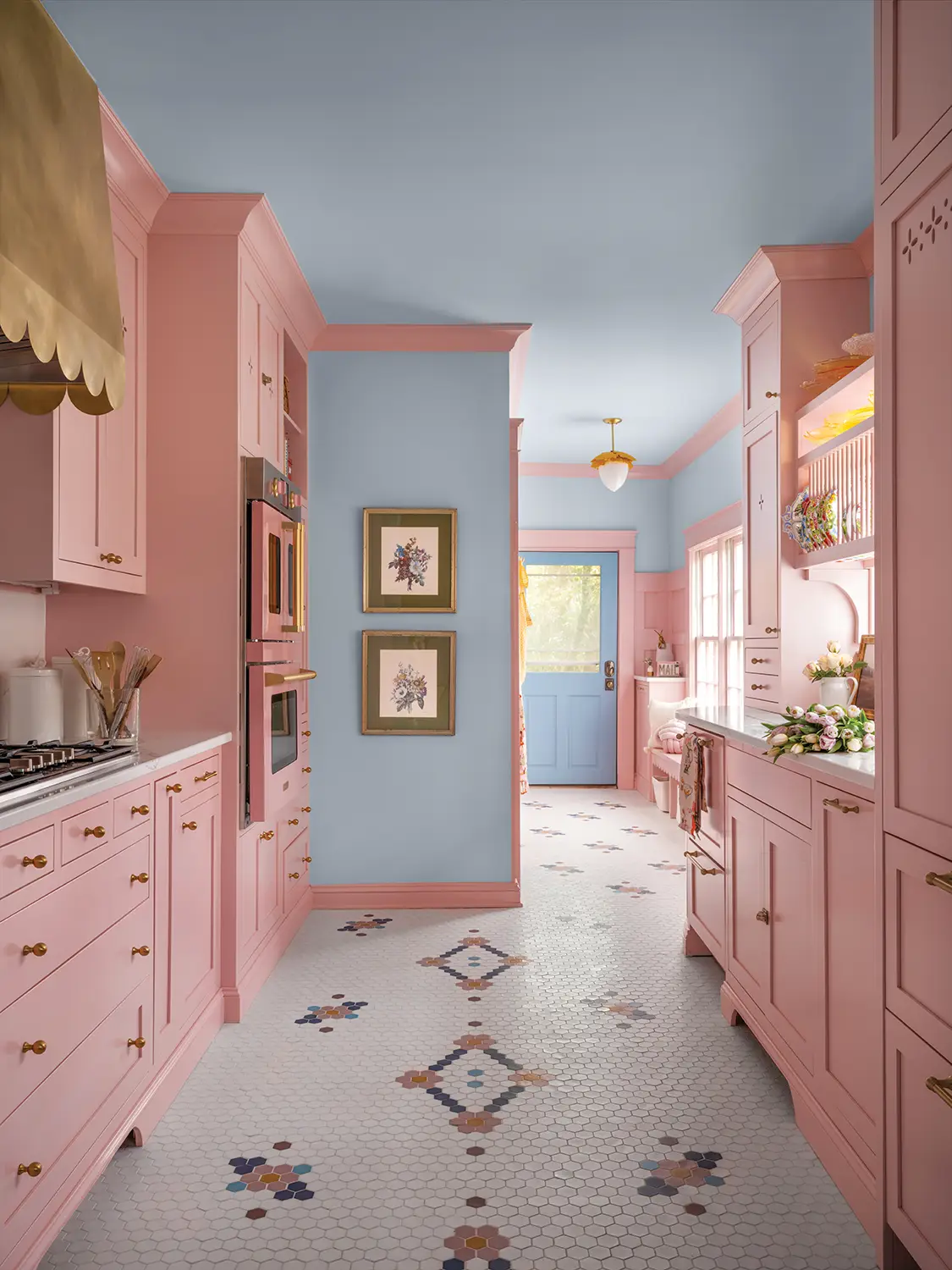 powder blue ceiling and accent walls with pink cabinetry in 1930 Tudor home entryway and kitchen