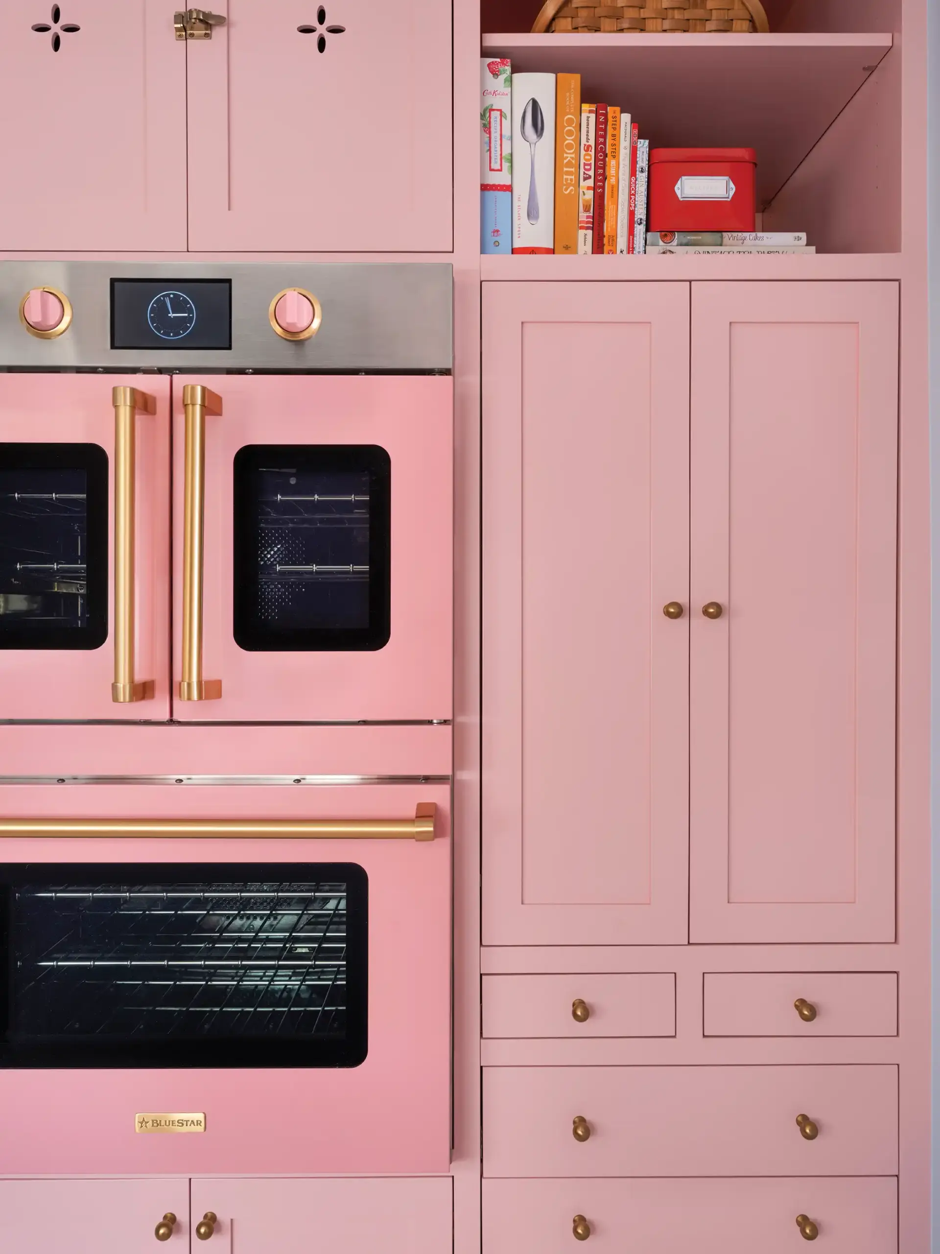 pink cabinetry and double oven in renovated 1930 Tudor home