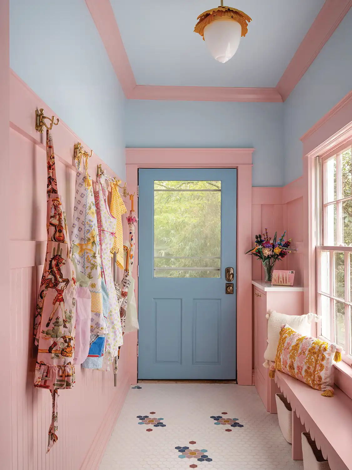 pink and powder blue entryway of renovated 1930 Tudor home