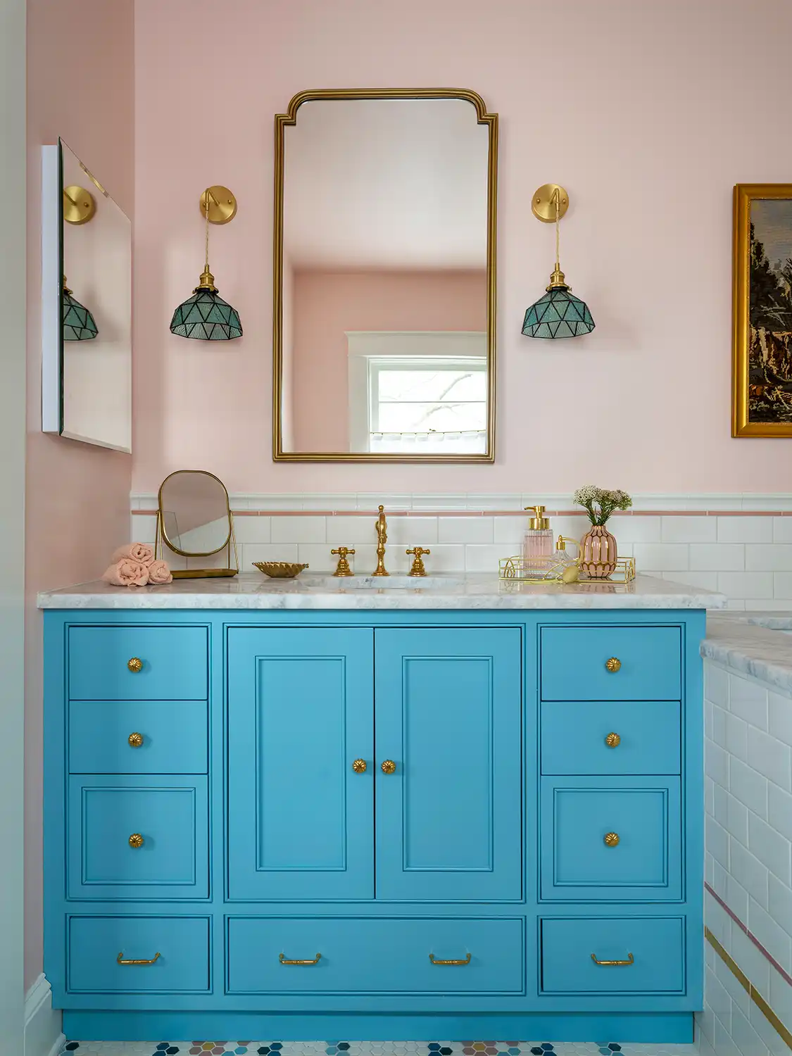 1930 Tudor home with pale pink half wall, white subway tile and blue vanity