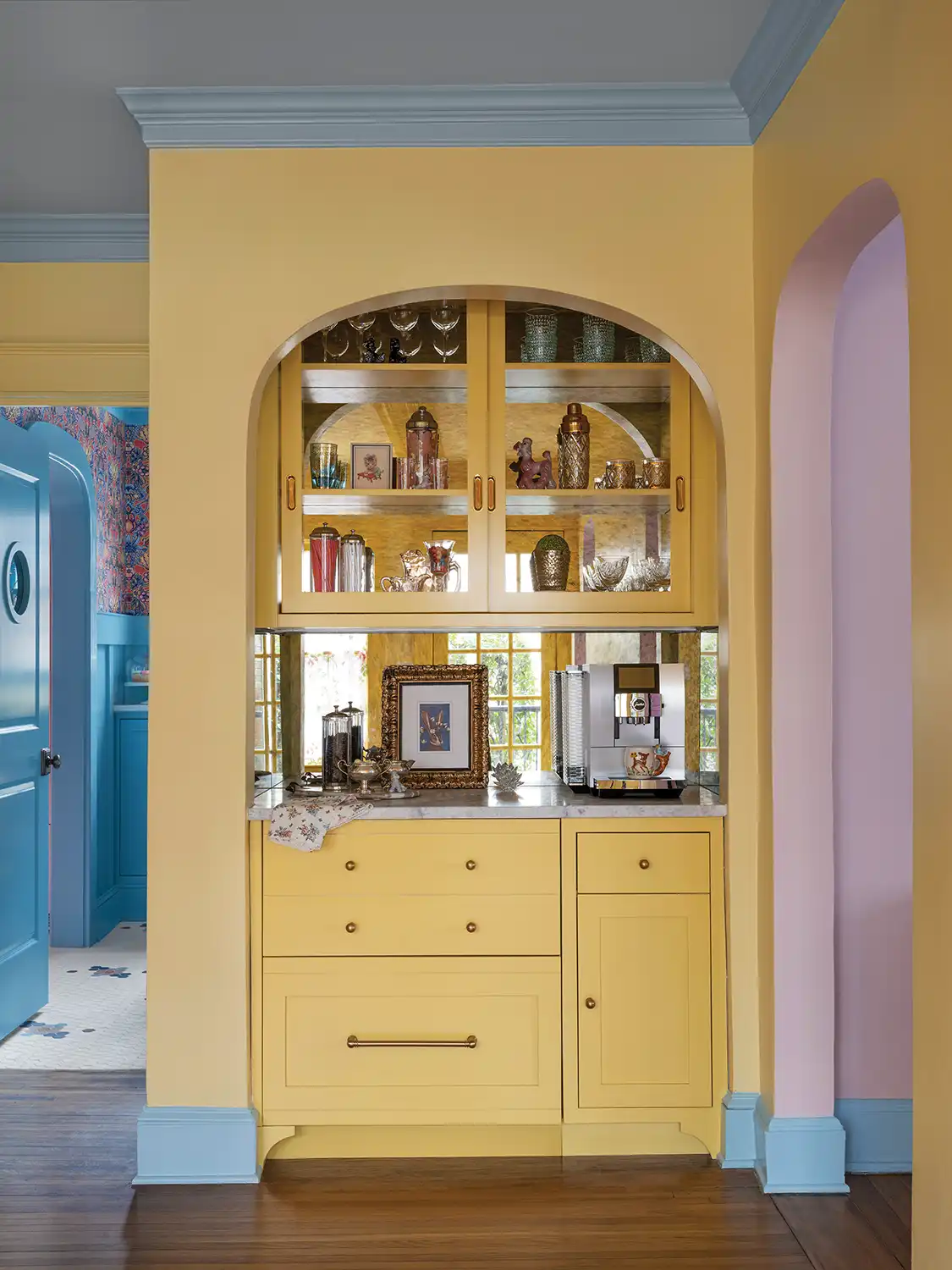 1930 Tudor home with yellow half wall and cabinetry and blue wood trim