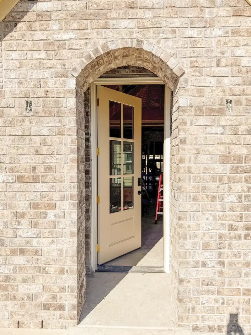 brick exterior of Project House Austin with entryway door